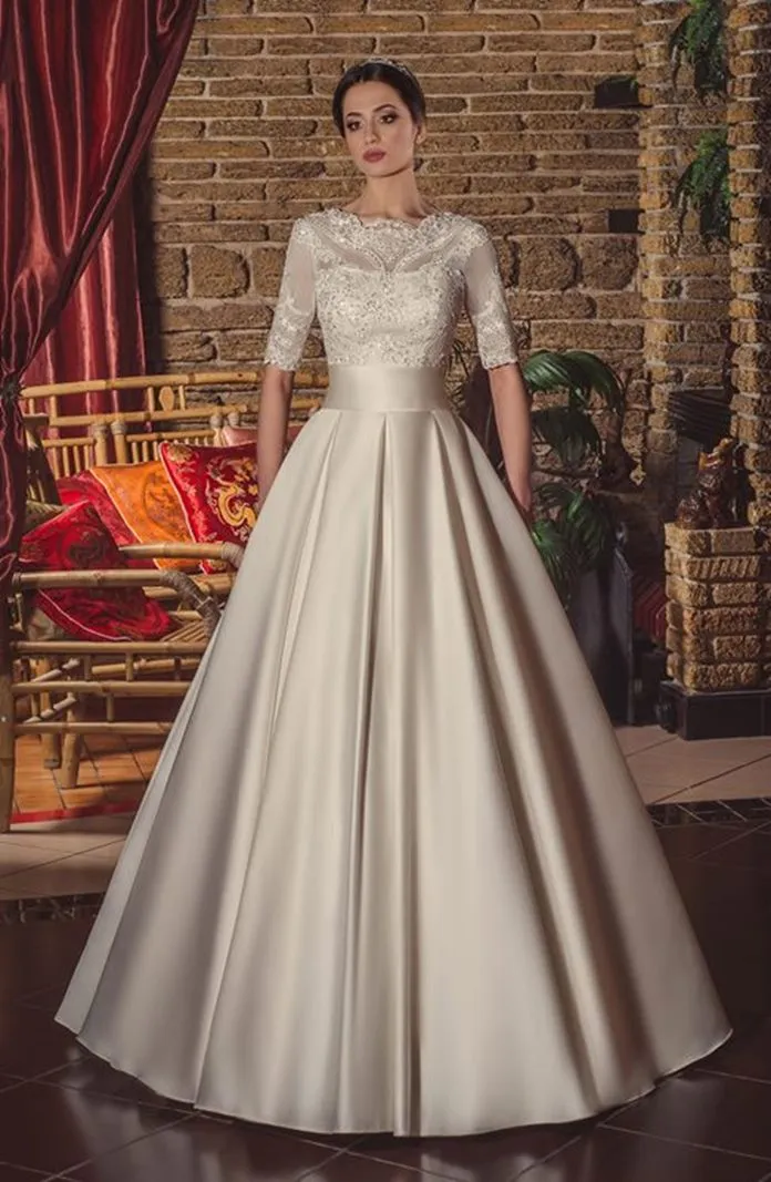 ---Traditional ivory wedding dress with beaded lace bodice, short sleeves, fitted waistband and full satin skirt. Sposamore comb